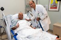 Dr. Ajay Kirtane bedside next to the first patient to receive the renal denervation ultrasound device
